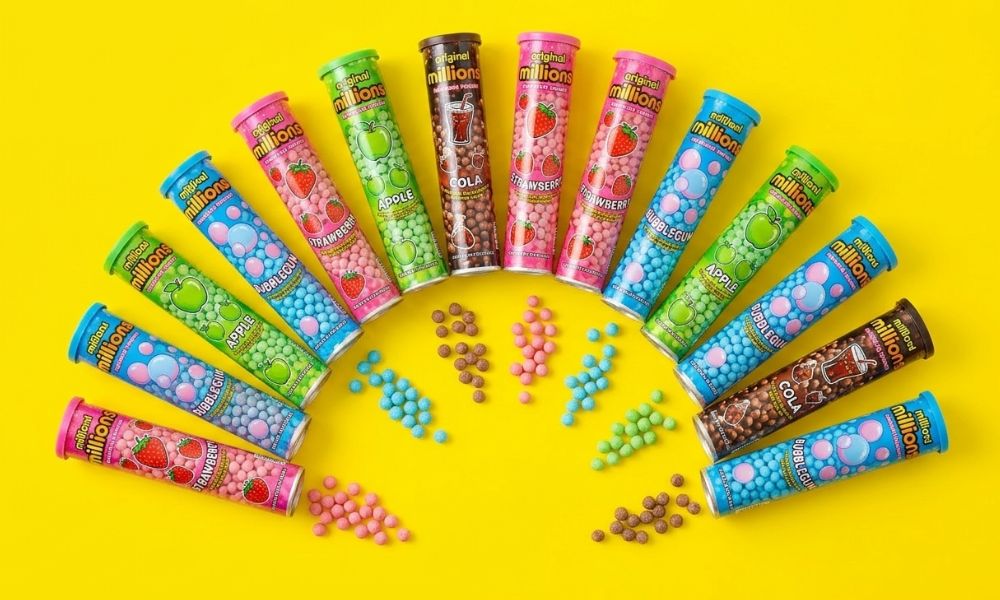tubes of millions sweets on a yellow background